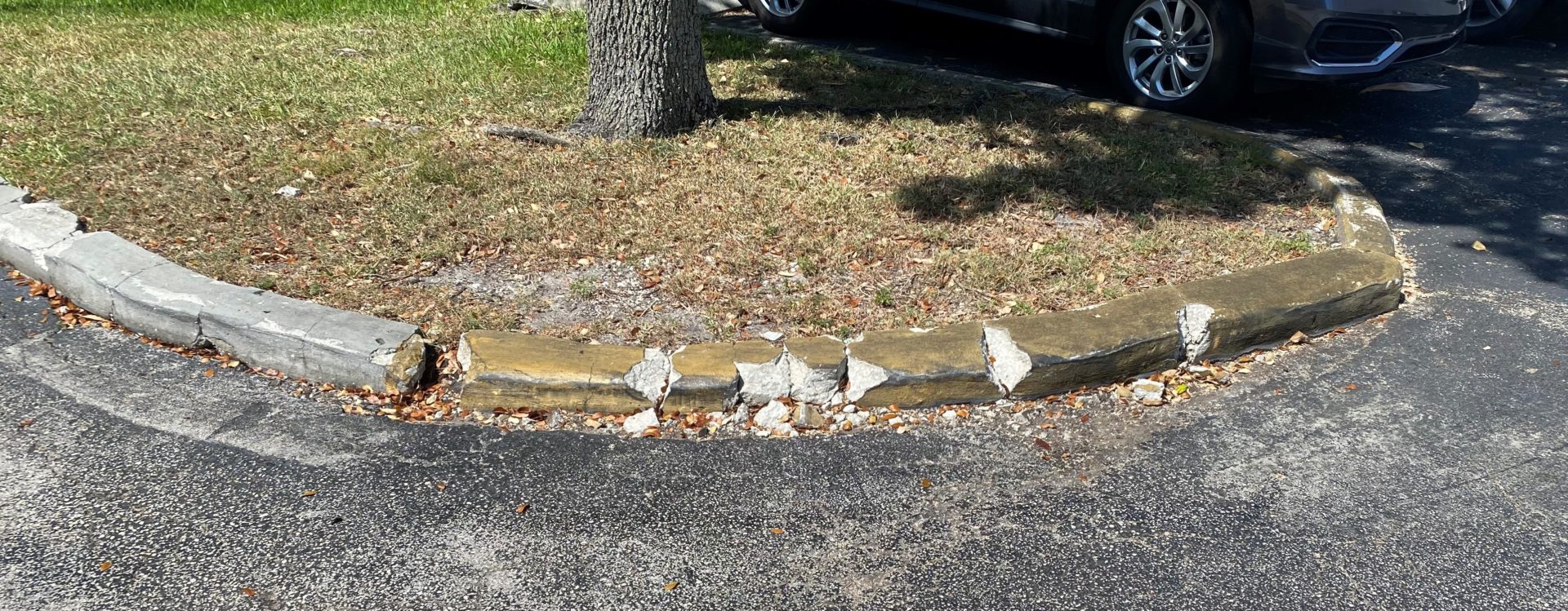 A curb that is little more than chunks of broken concrete from being run over too many times