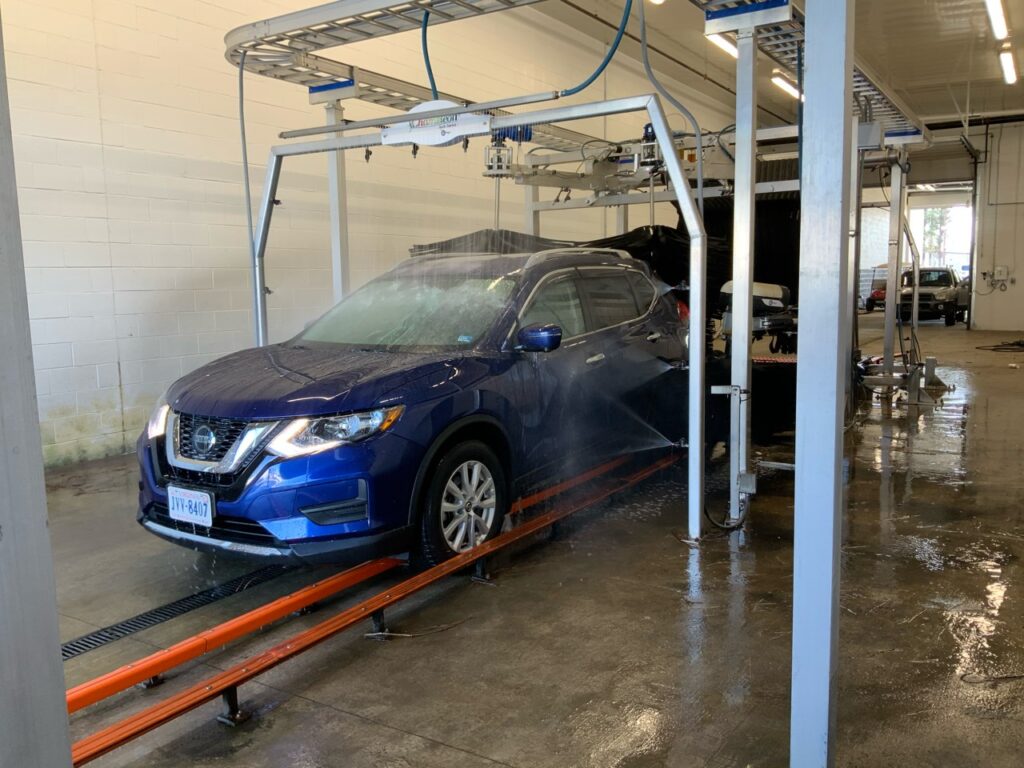 washing a customer's car with a modern dealership car wash system