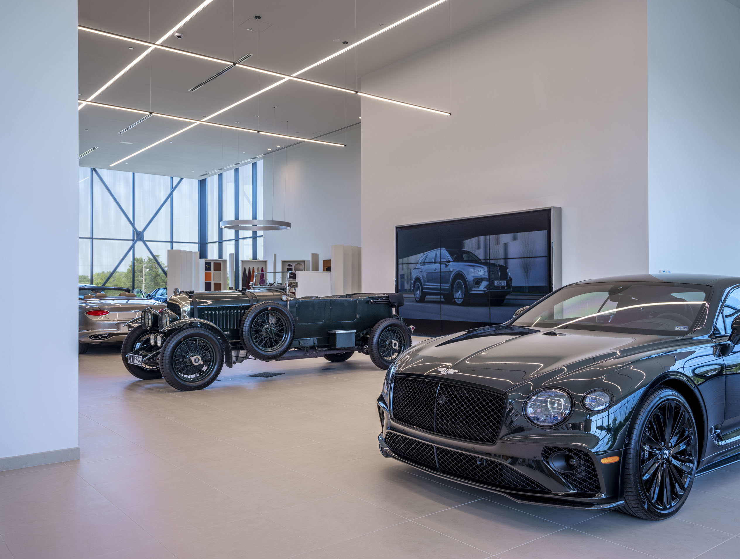 Showroom with cars at the Exclusive Automotive Aston Martin/Bentley of Loudon