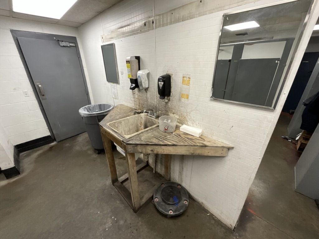 a worn out and dirty wash sink in a technician bathroom
