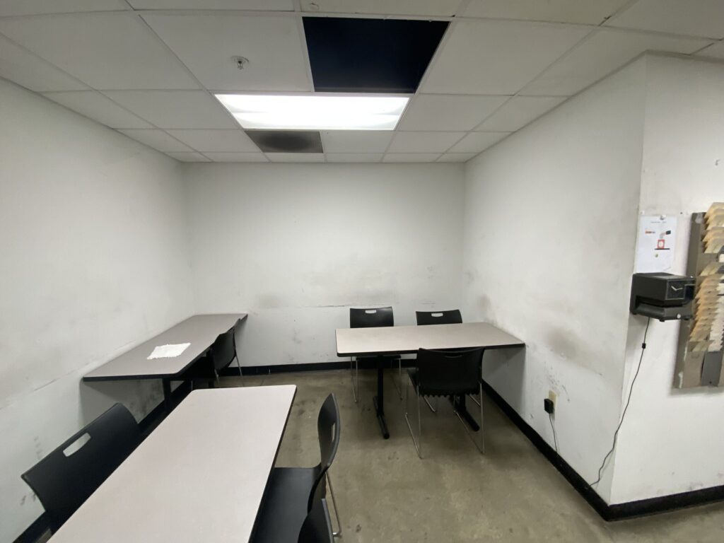 Technician breakroom with dirty walls and worn out furniture