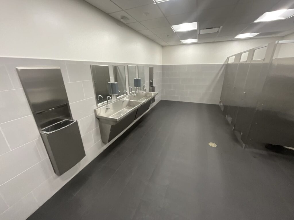 fully renovated bathroom for technicians with new stainless steel fixtures