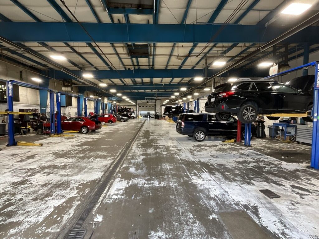 Dirty and worn dealership workshop floor. The four main flooring options for your service drive, workshop and detail bays