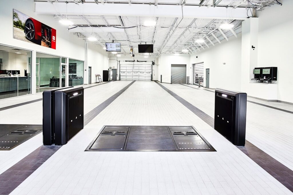 A fully tiled and clean dealership service drive. The four main flooring options for your service drive, workshop and detail bays