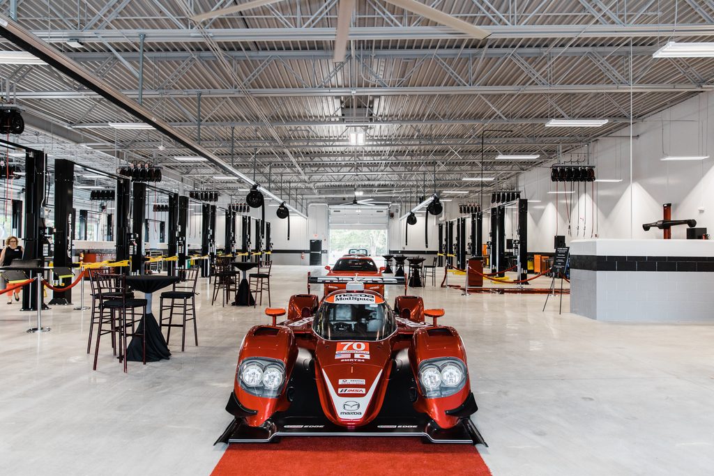 Race car on display inside a brand new dealership work shop